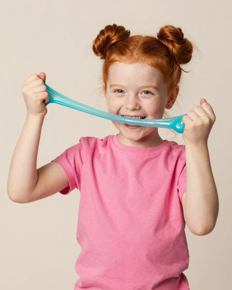 A child stretching a strand of turquoise glitter slime